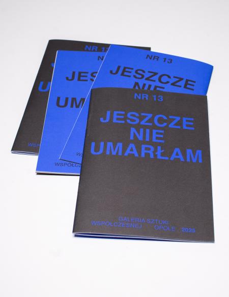 okładka gazetki z napisem: jeszcze nie umarłam, niebieskie lub czarne tło